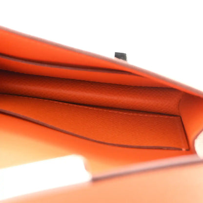 Orange Epsom leather slim wallet interior edge seam close-up.