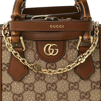 Mini tote bag front detail with GG monogram canvas, GG logo plaque, and gold-tone chain