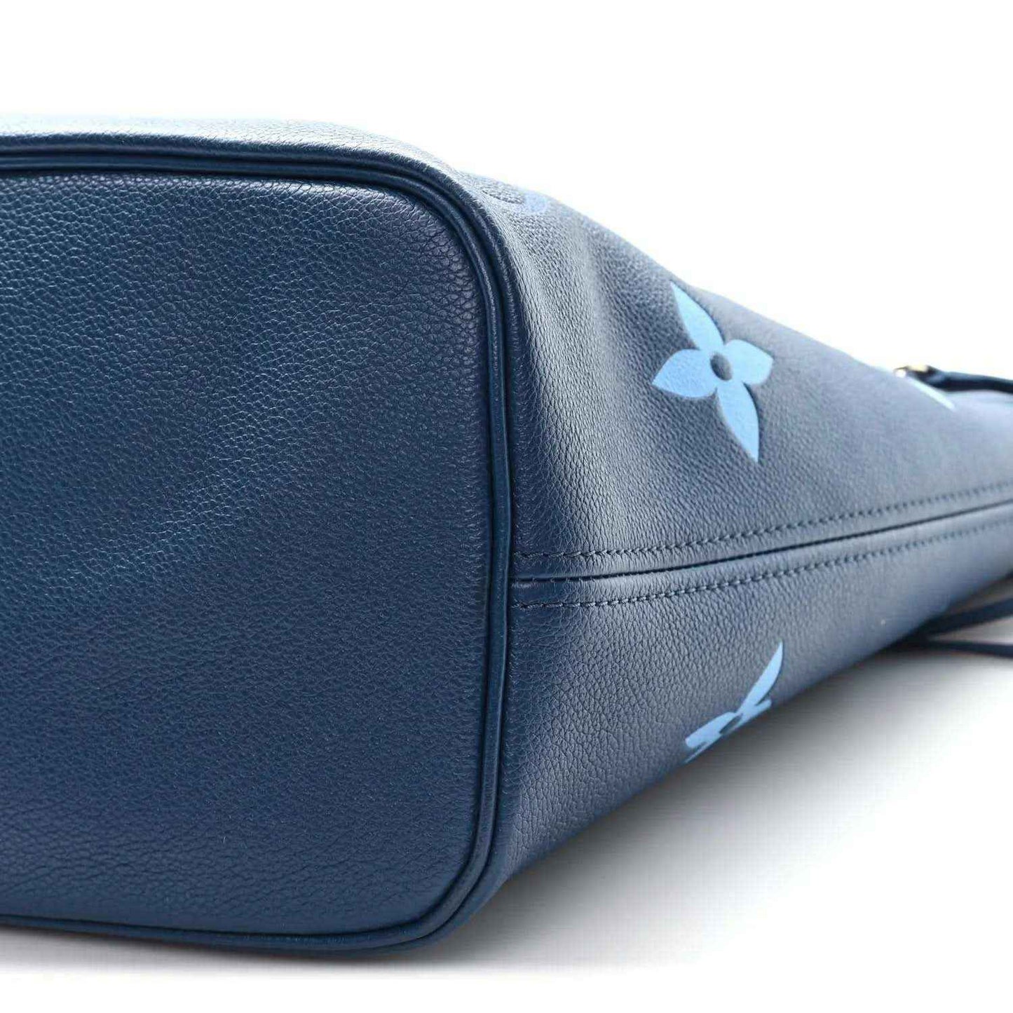 Blue monogram tote bag close-up of rounded corner and side panel