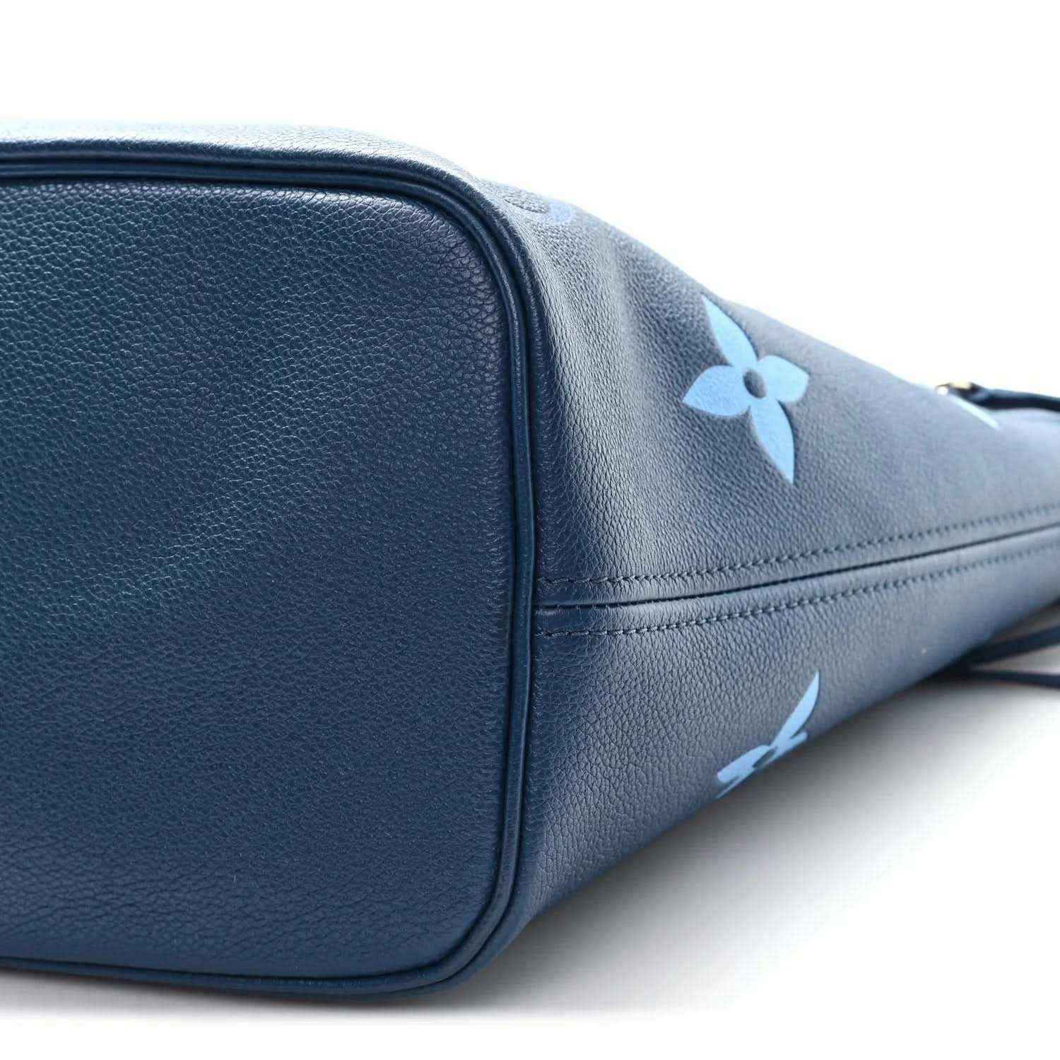 Blue monogram tote bag close-up of rounded corner and side panel