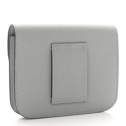 Hermes Constance slim wallet back, light blue textured leather with centered patch.