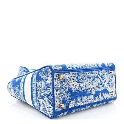 Christian Dior medium tote bag in blue and white toile print with zipper top and gold hardware