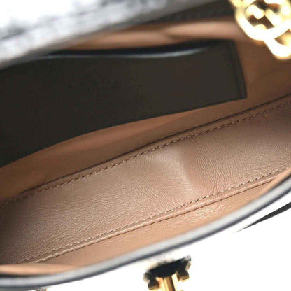 Mini Jackie handbag interior lining with tan leather and gold-tone clasp hardware detail.