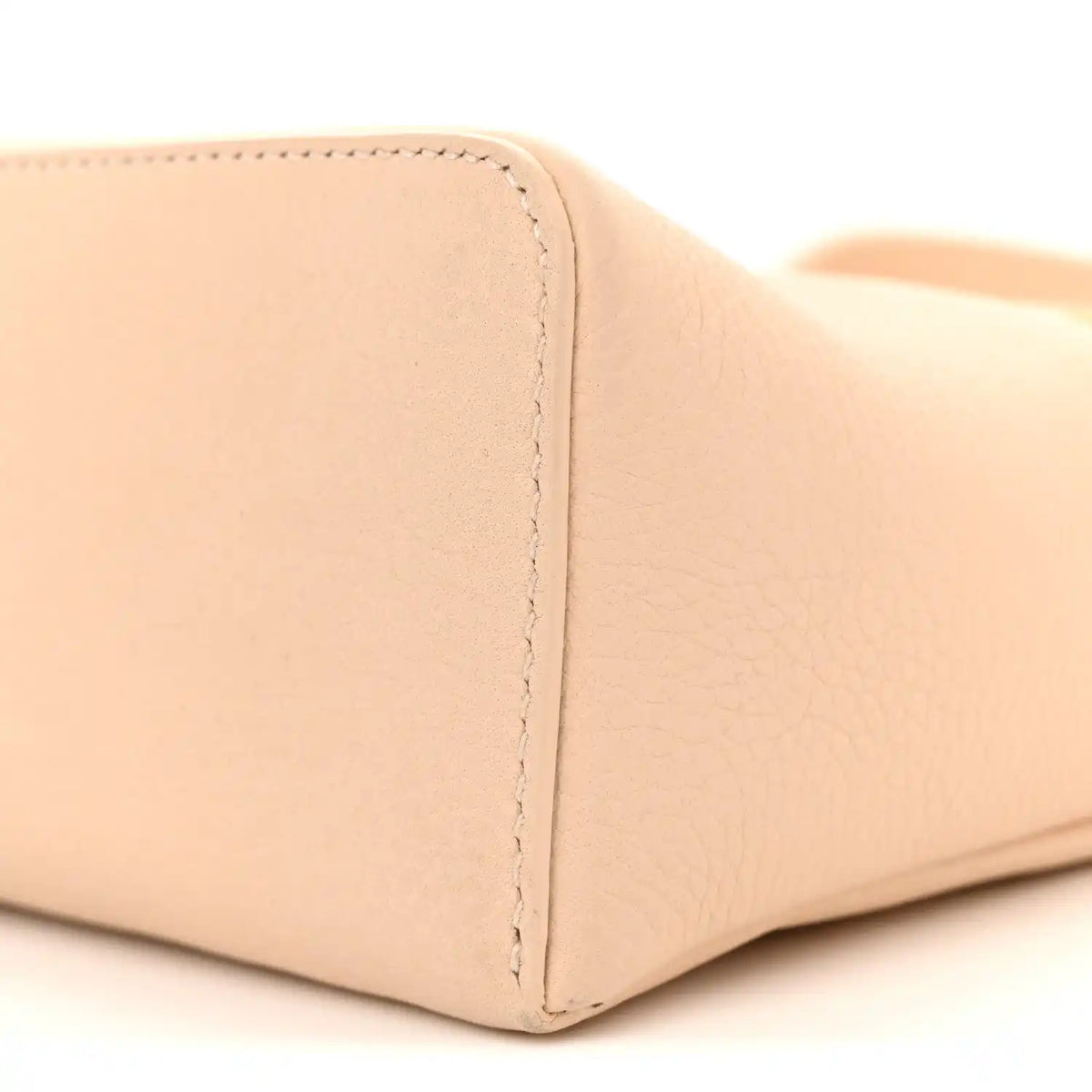 Cream leather pouch base corner with seam and textured grain