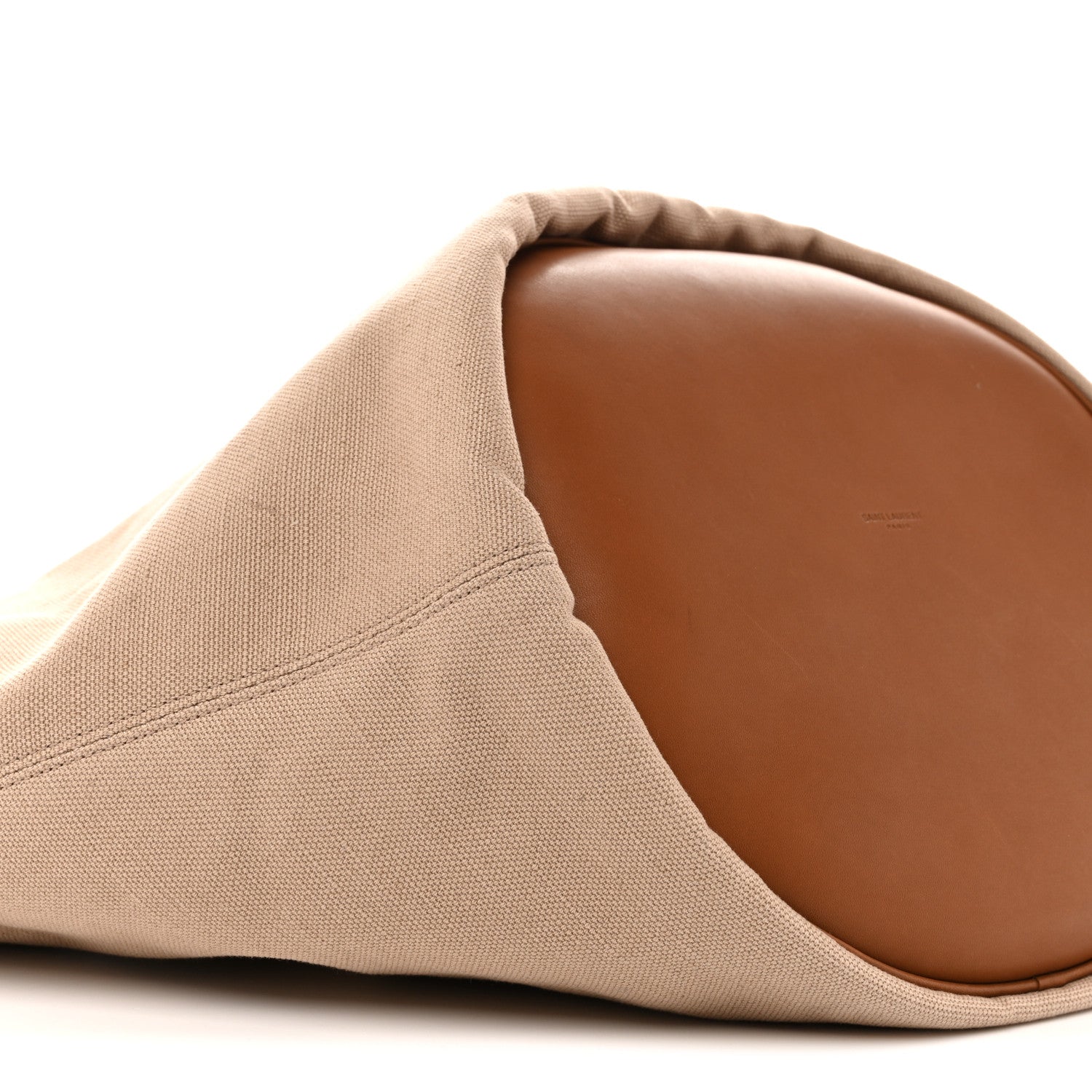 Desert dust canvas tote with brown leather-lined base and curved seam
