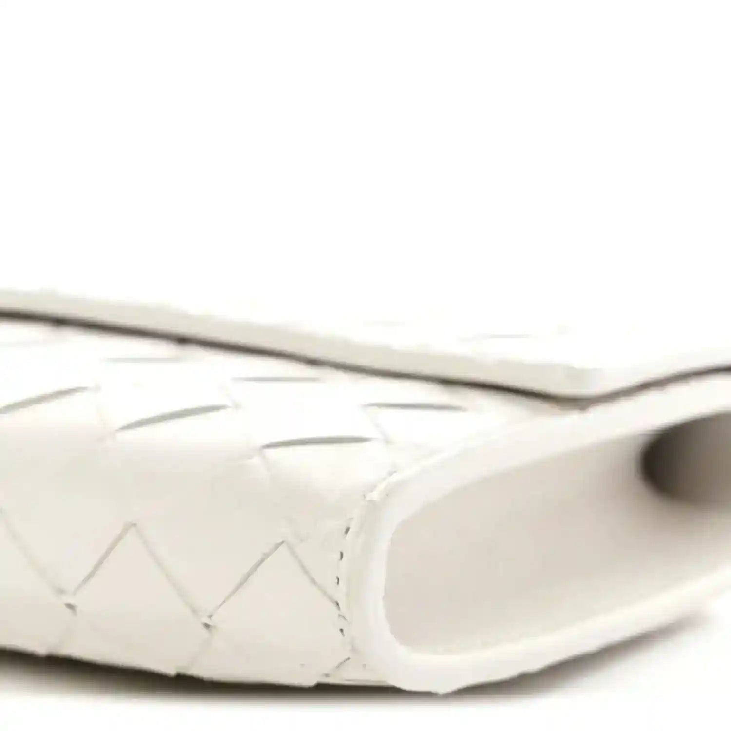 White nappa clutch close-up of curved side and interior opening edge