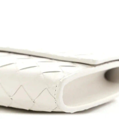 White nappa clutch close-up of curved side and interior opening edge