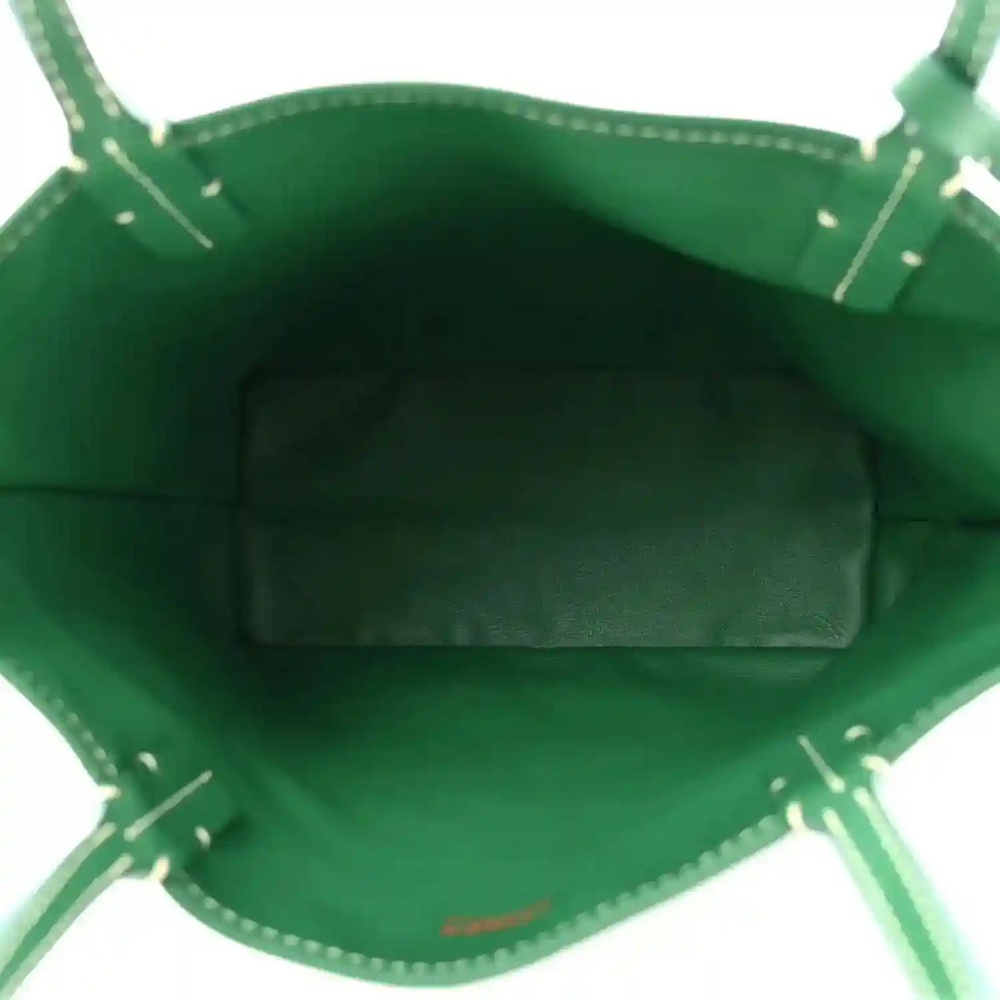 Green interior pocket of the reversible tote bag with stitched trim