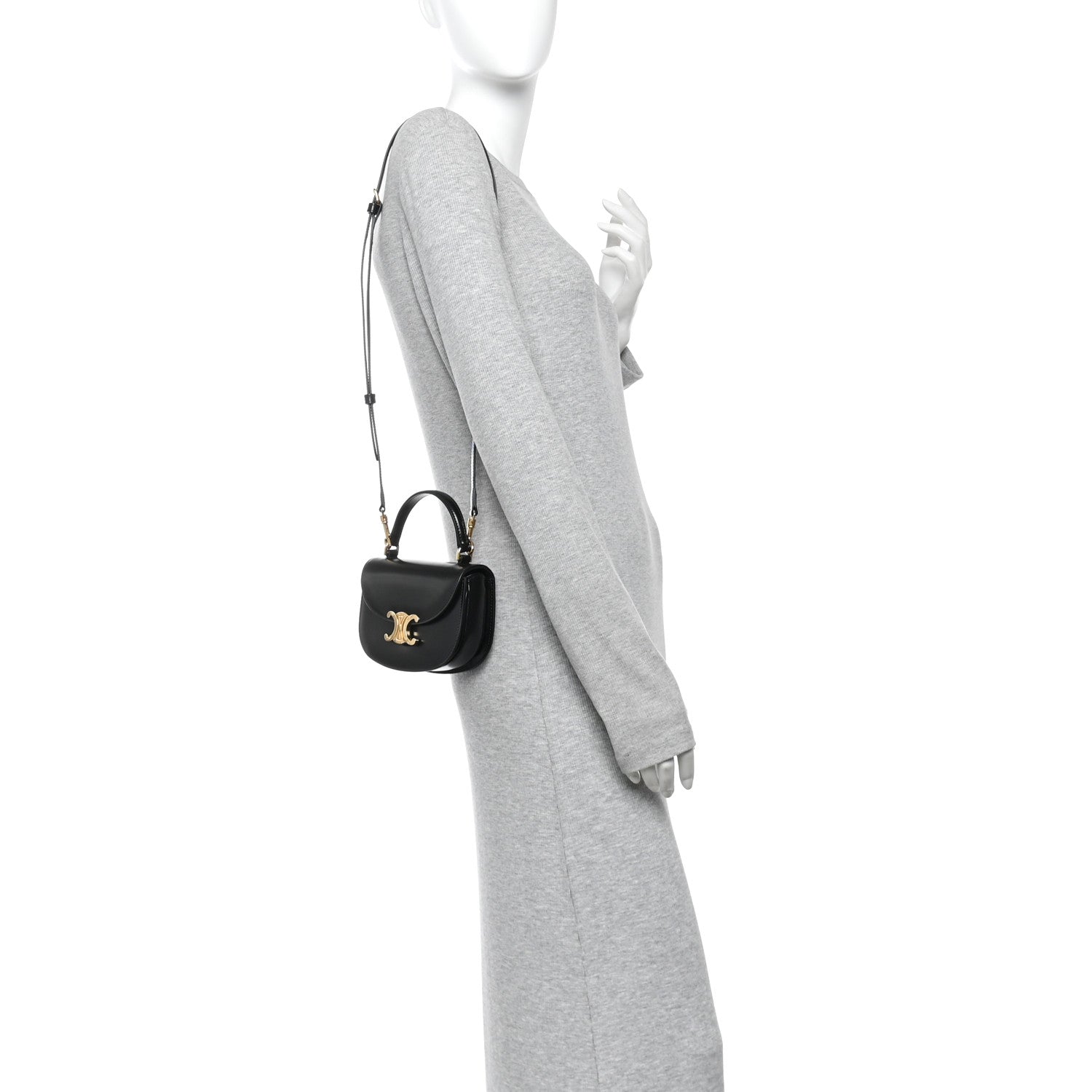Black mini crossbody bag with short strap and gold-tone logo on front