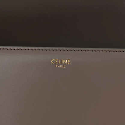 Celine branding on interior of shiny calfskin shoulder bag, gold lettering on dark taupe