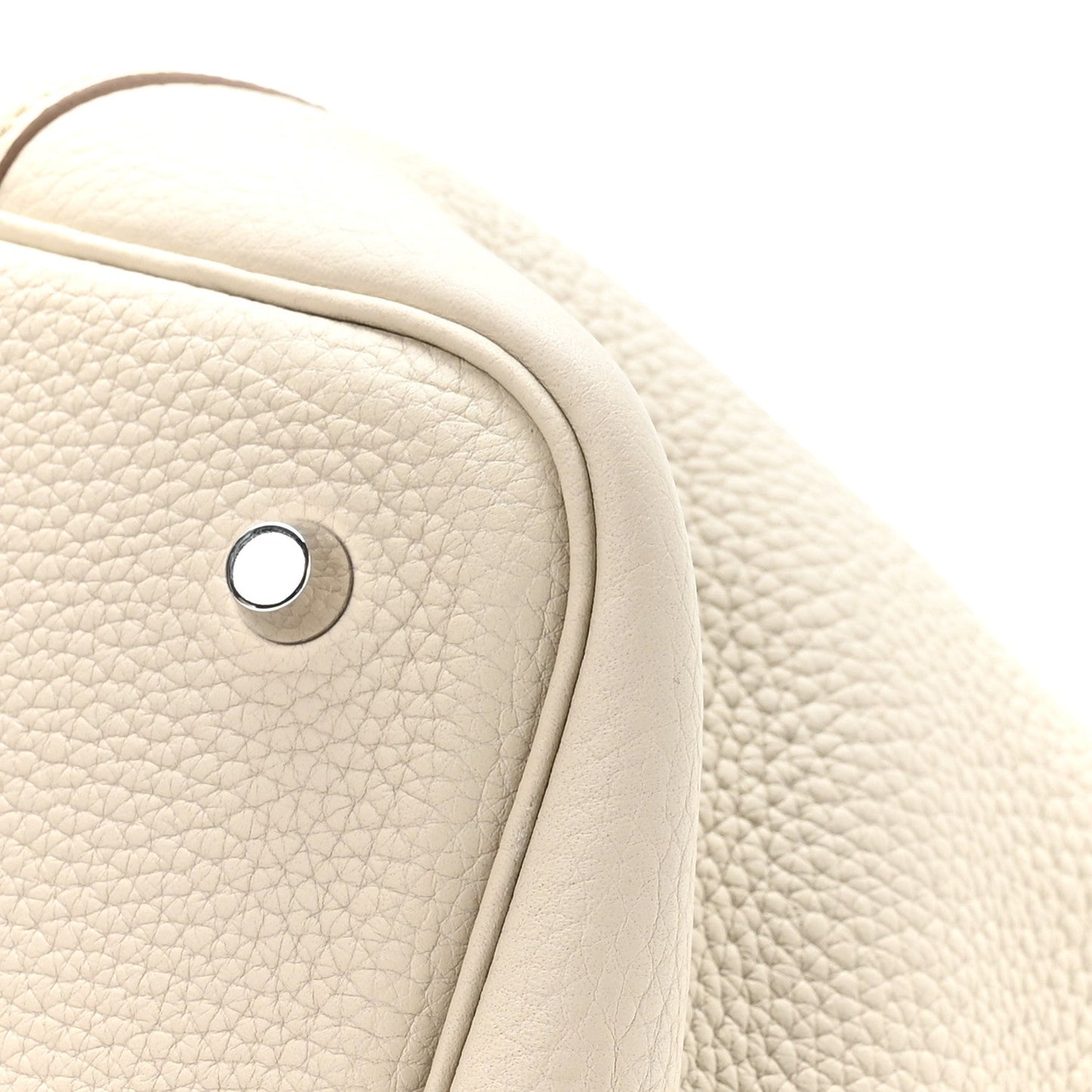 Ivory leather tote bag close-up of handle base and metal snap