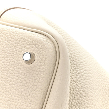 Ivory leather tote bag close-up of handle base and metal snap