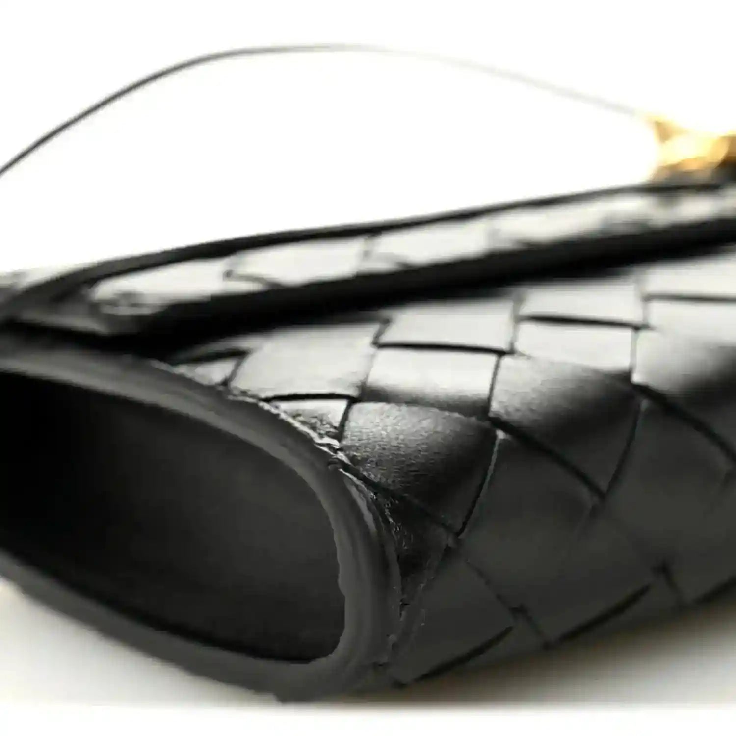 Black leather clutch interior lining and woven trim at opening