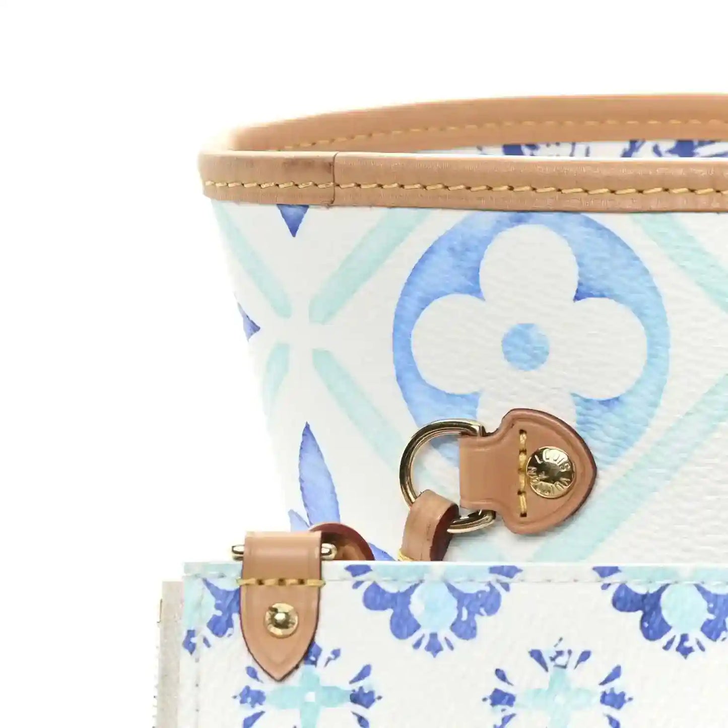 Blue monogram tote bag with tan leather handle straps and gold-tone hardware