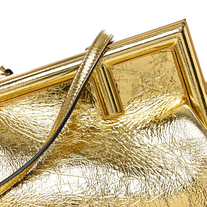 Metallic gold leather bag with textured finish and top clasp frame