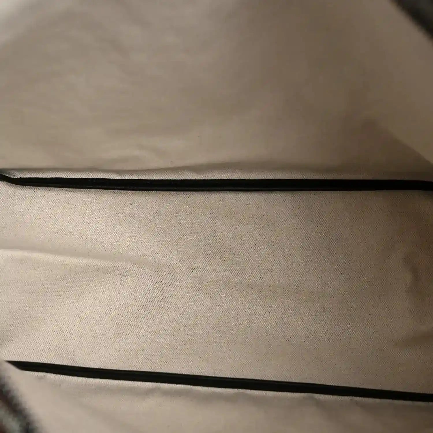 Coated canvas lining of Goyard hobo bag interior with black edge piping