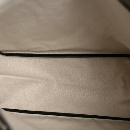 Coated canvas lining of Goyard hobo bag interior with black edge piping