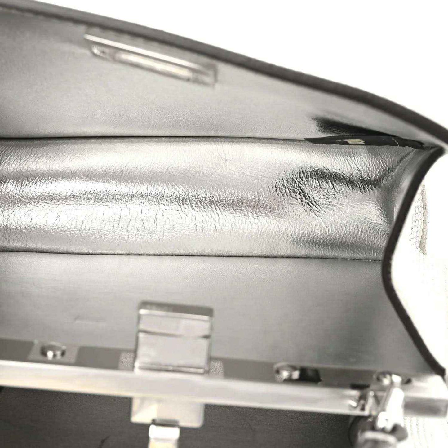 Silver-tone clasp and interior lining detail on a satchel