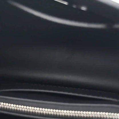 Black leather handbag zipper with silver teeth and zipper pull