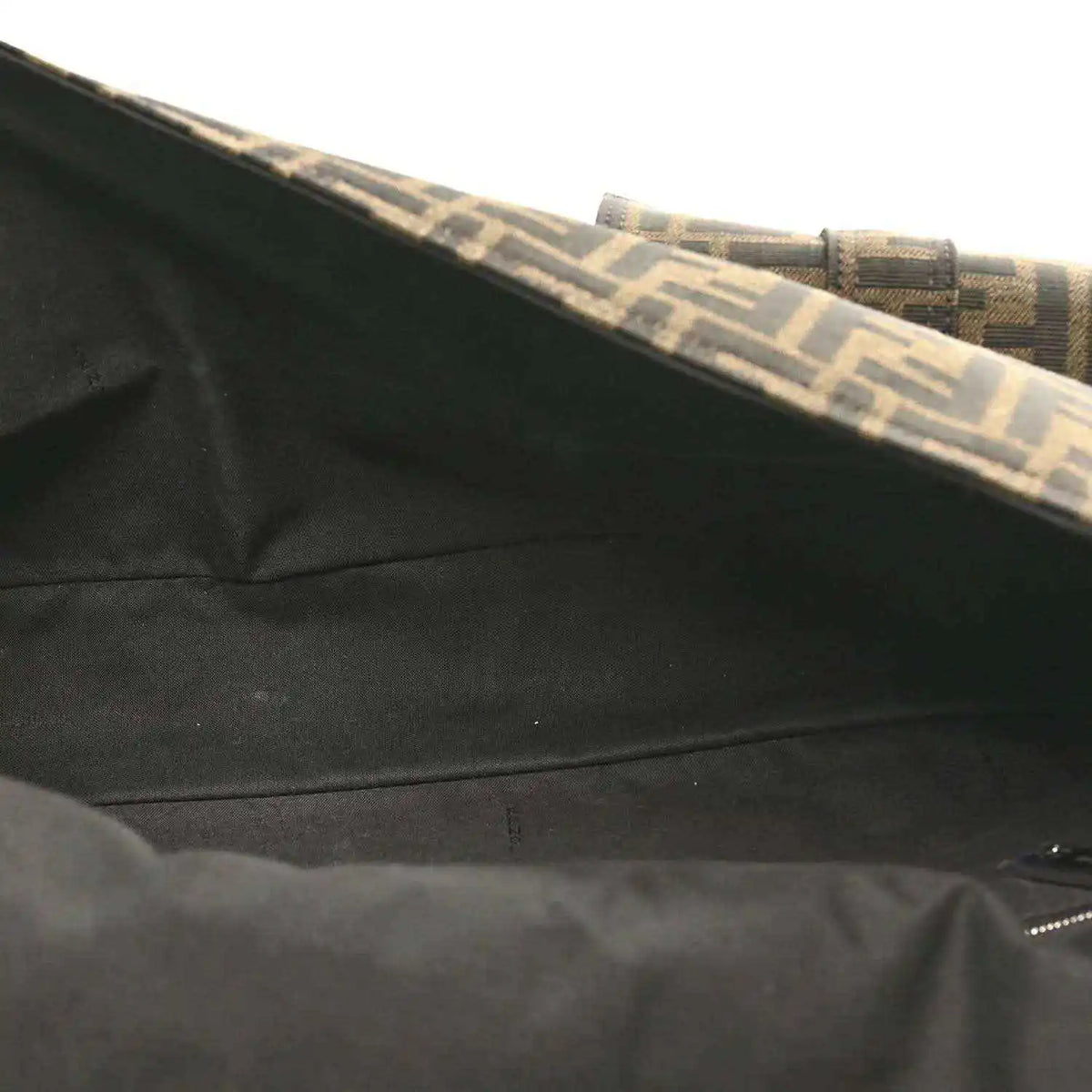 Baguette bag interior lining near top edge, dark fabric with Zucca trim.