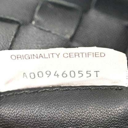Bottega Veneta originality certified label on black leather bag lining.