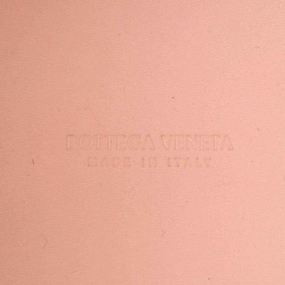 Pink leather bag surface with embossed Bottega Veneta logo
