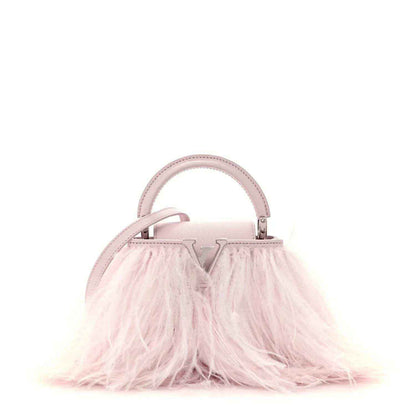 Louis Vuitton mini top-handle bag with pale pink handle and feather-front fringe