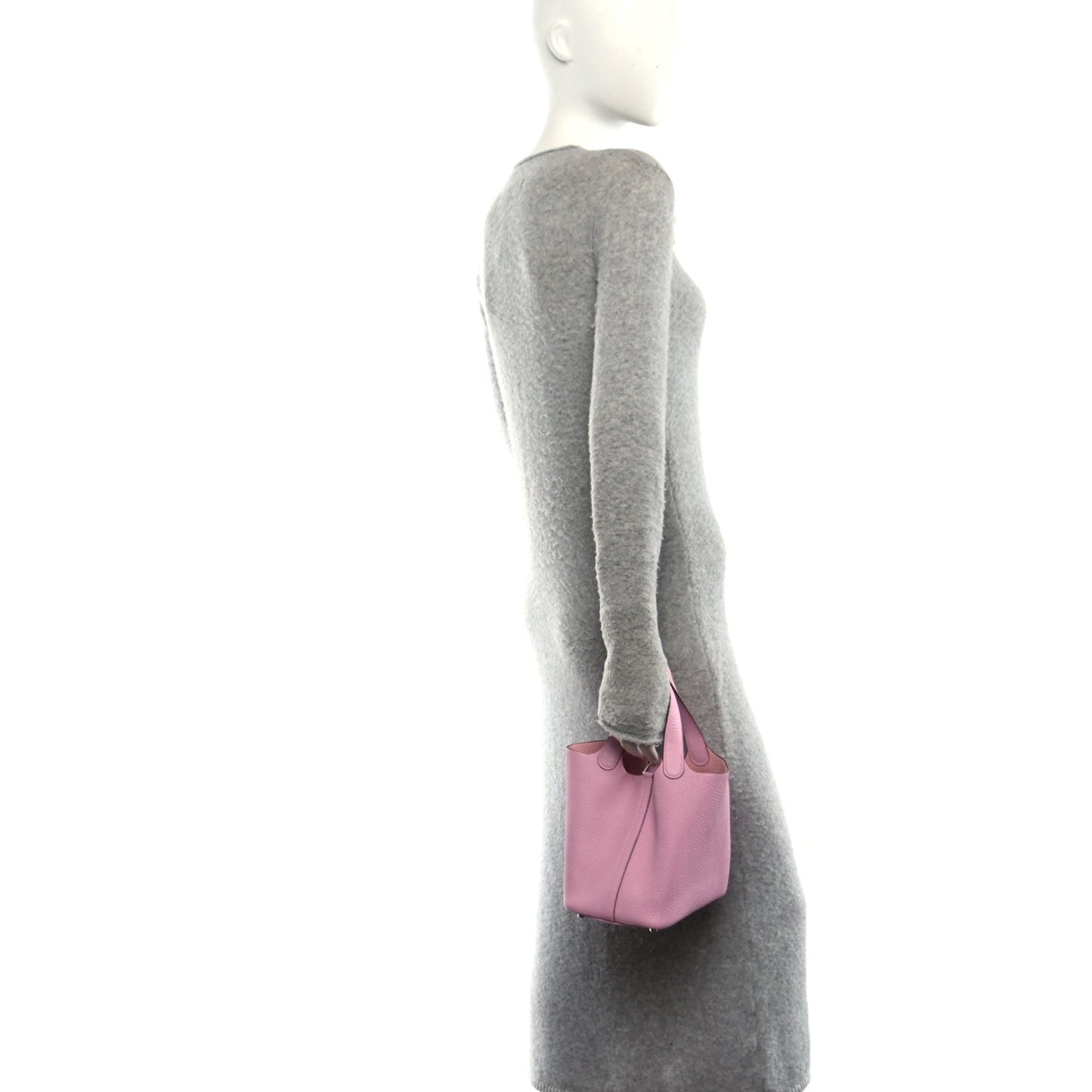 Rose pink mini handbag carried by a model with short top handles