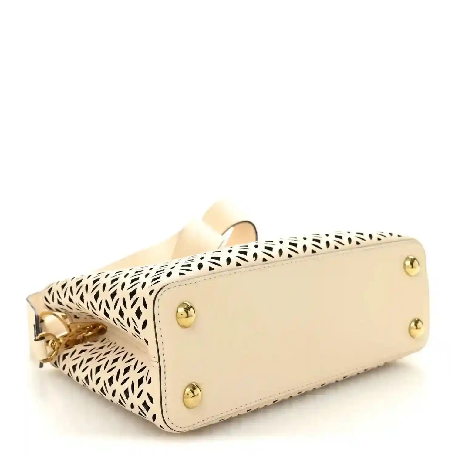 Louis Vuitton mini handbag side view with gold studs and cut-out lattice panel
