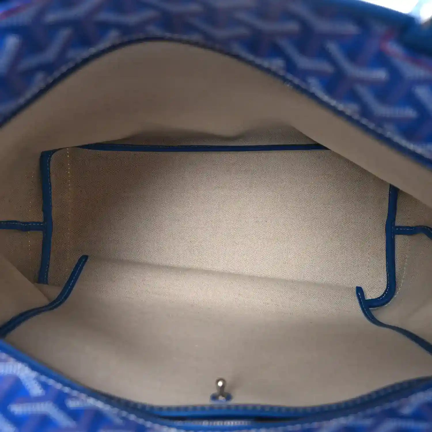Interior view of sky blue patterned tote bag with fabric lining and top opening hardware