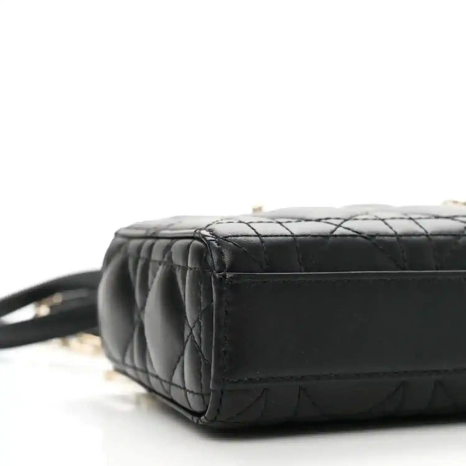 Black lambskin micro handbag with quilted texture and side panel, close-up