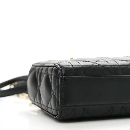 Black lambskin micro handbag with quilted texture and side panel, close-up