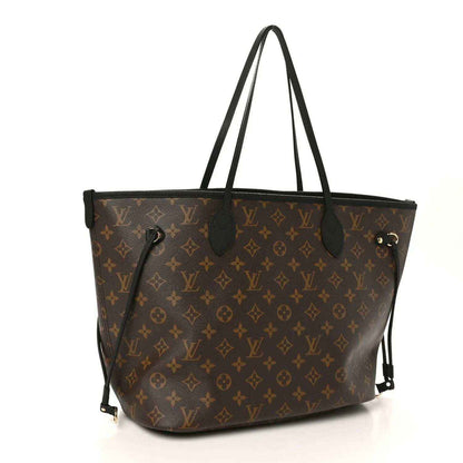 Monogram tote bag with black handles and gold-tone hardware, front view