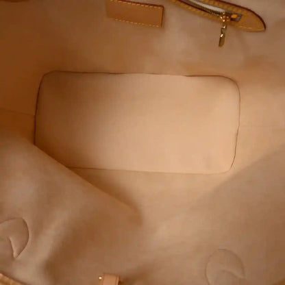 Beige fabric interior panel with stitched seams inside a zip pouch