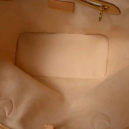 Beige fabric interior panel with stitched seams inside a zip pouch