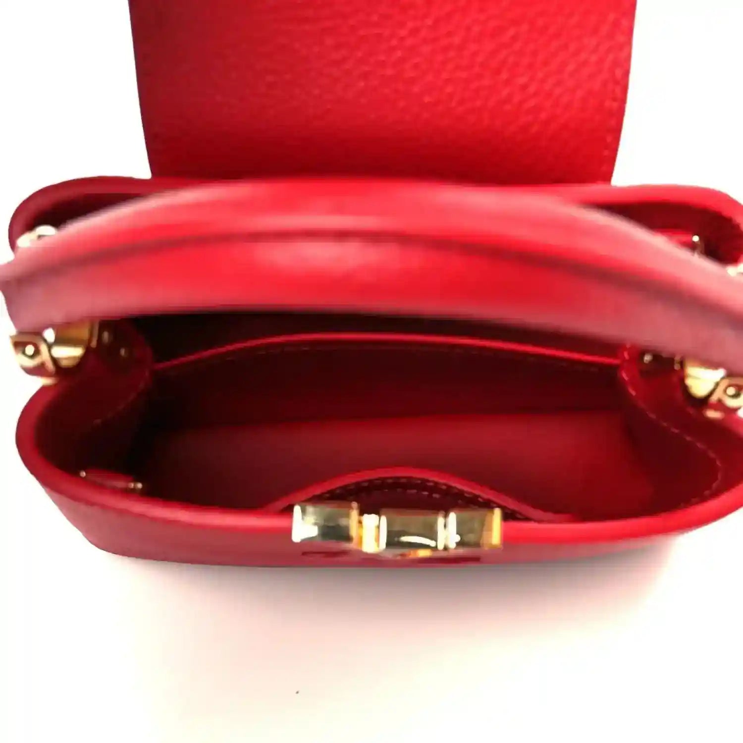 Louis Vuitton scarlet mini handbag interior view with red lining and gold-tone clasp