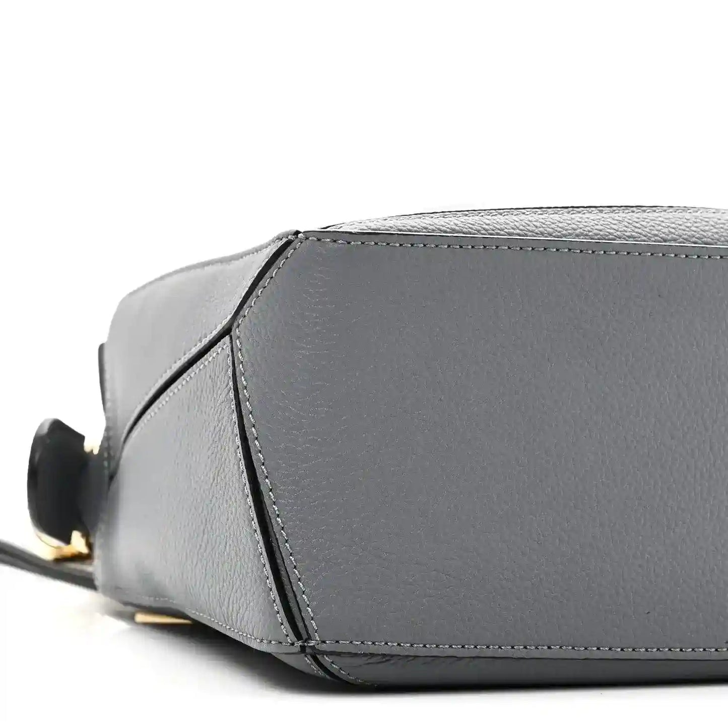Small puzzle bag side view in dark gray leather with contrast edge stitching and base