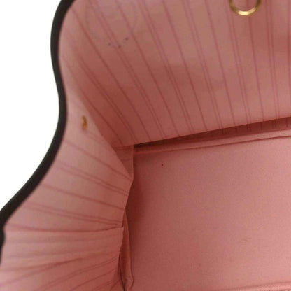 Neverfull tote interior with light pink fabric lining and stitched edge