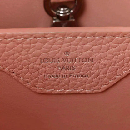Louis Vuitton Paris leather stamp on pink handbag with visible stitching