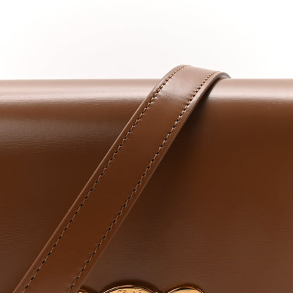 Calfskin crossbody strap with visible stitching and flap edge
