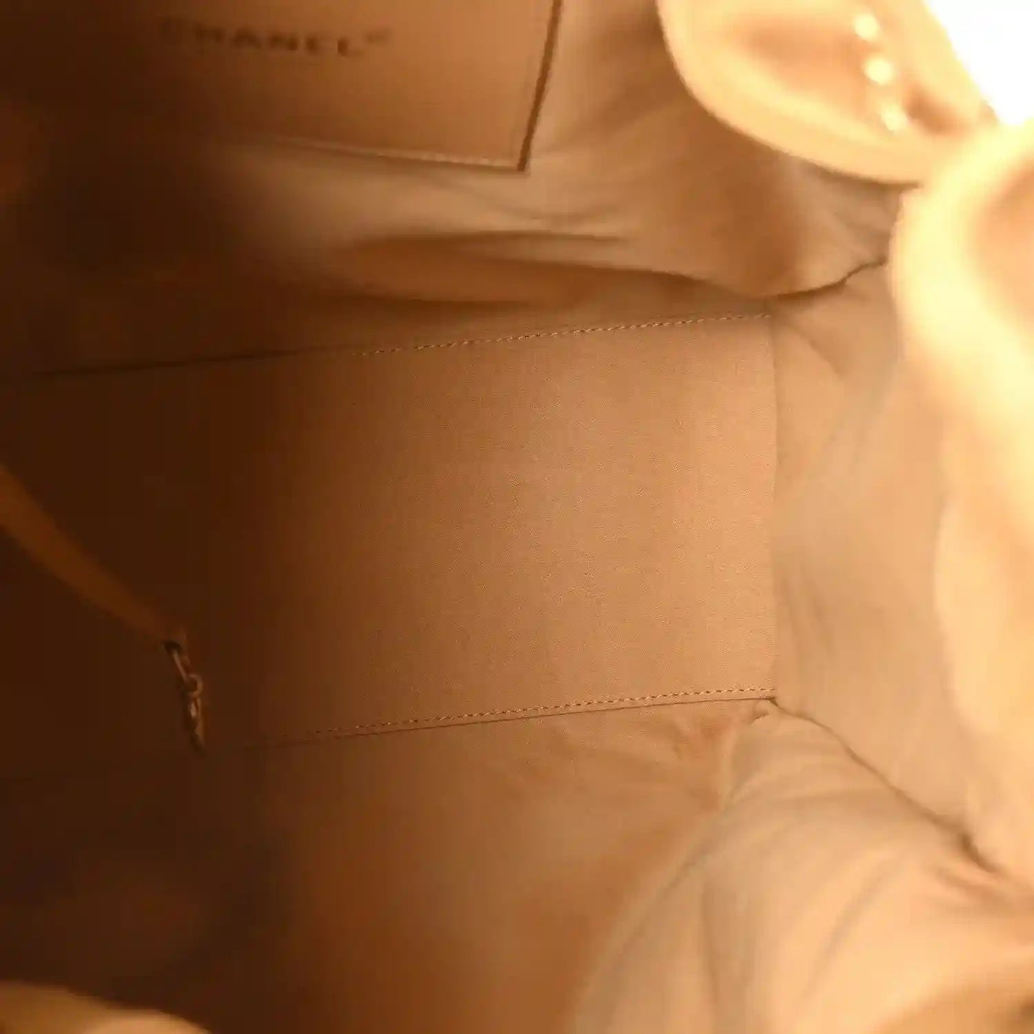 Chanel suede handbag interior in classic beige with stitched seam
