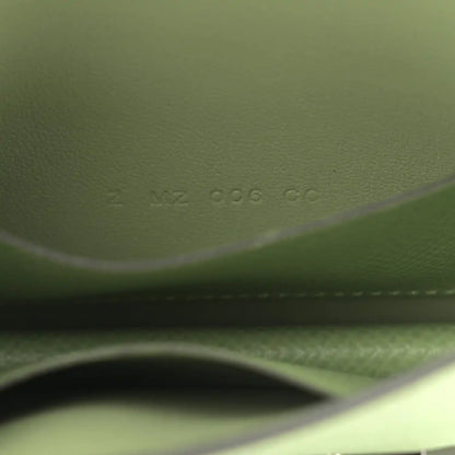Light green leather wallet close-up of embossed code and stitching