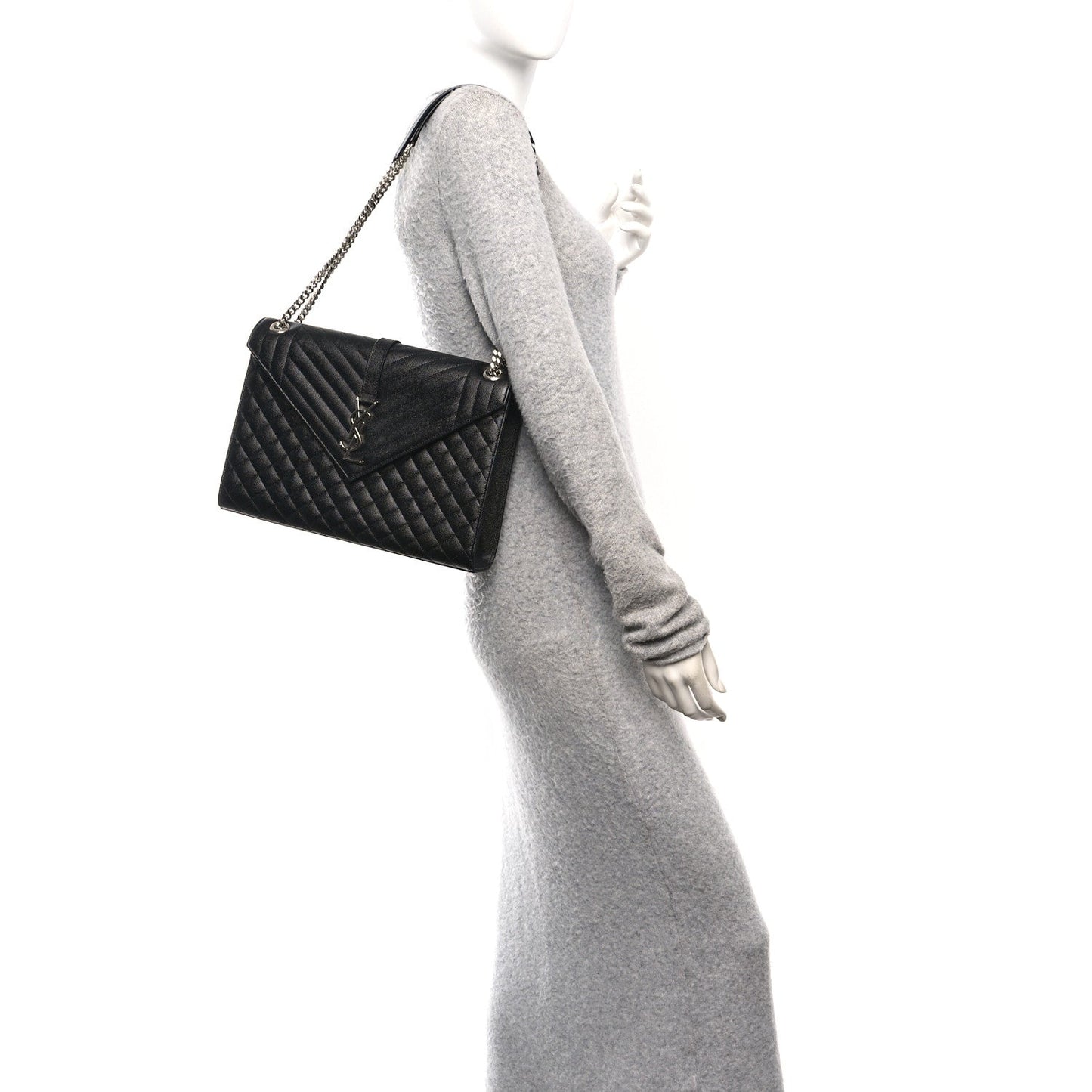 Black quilted mini satchel worn crossbody with chain strap and front flap