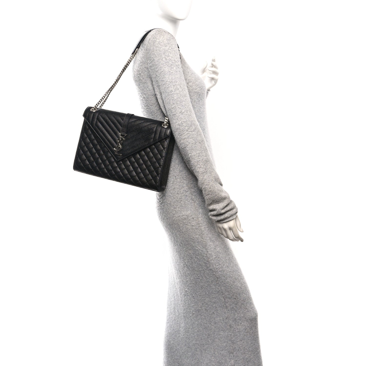 Black quilted mini satchel worn crossbody with chain strap and front flap