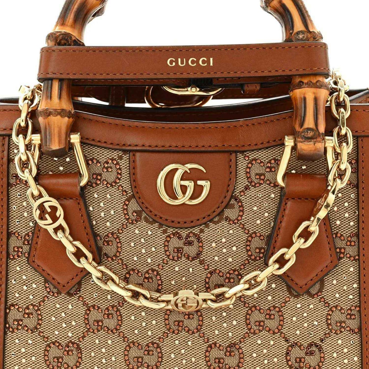 Gucci mini tote bag top front with bamboo handle, Gucci logo, and gold chain strap.
