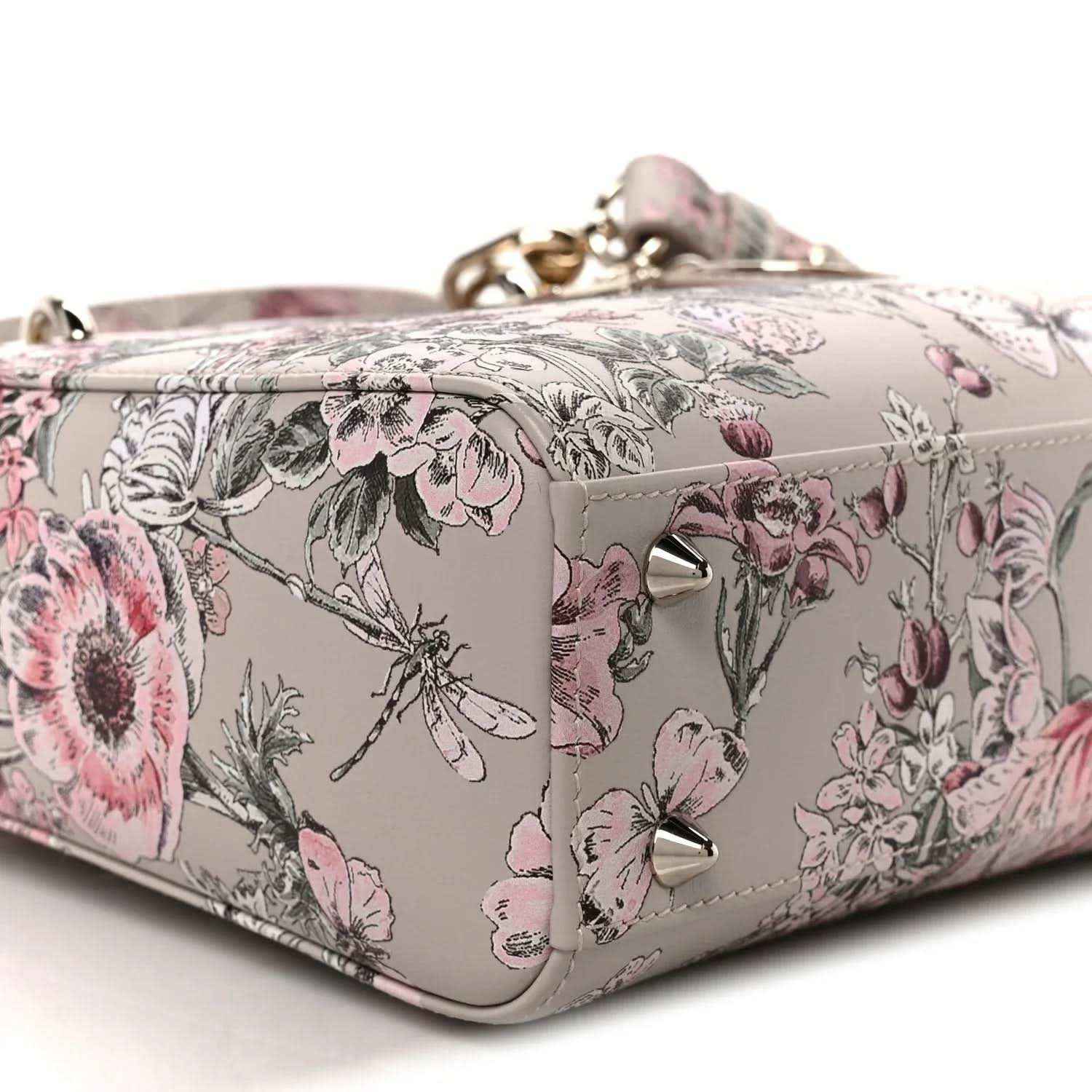Small Lady Dior handbag corner view with pink floral print and light leather trim