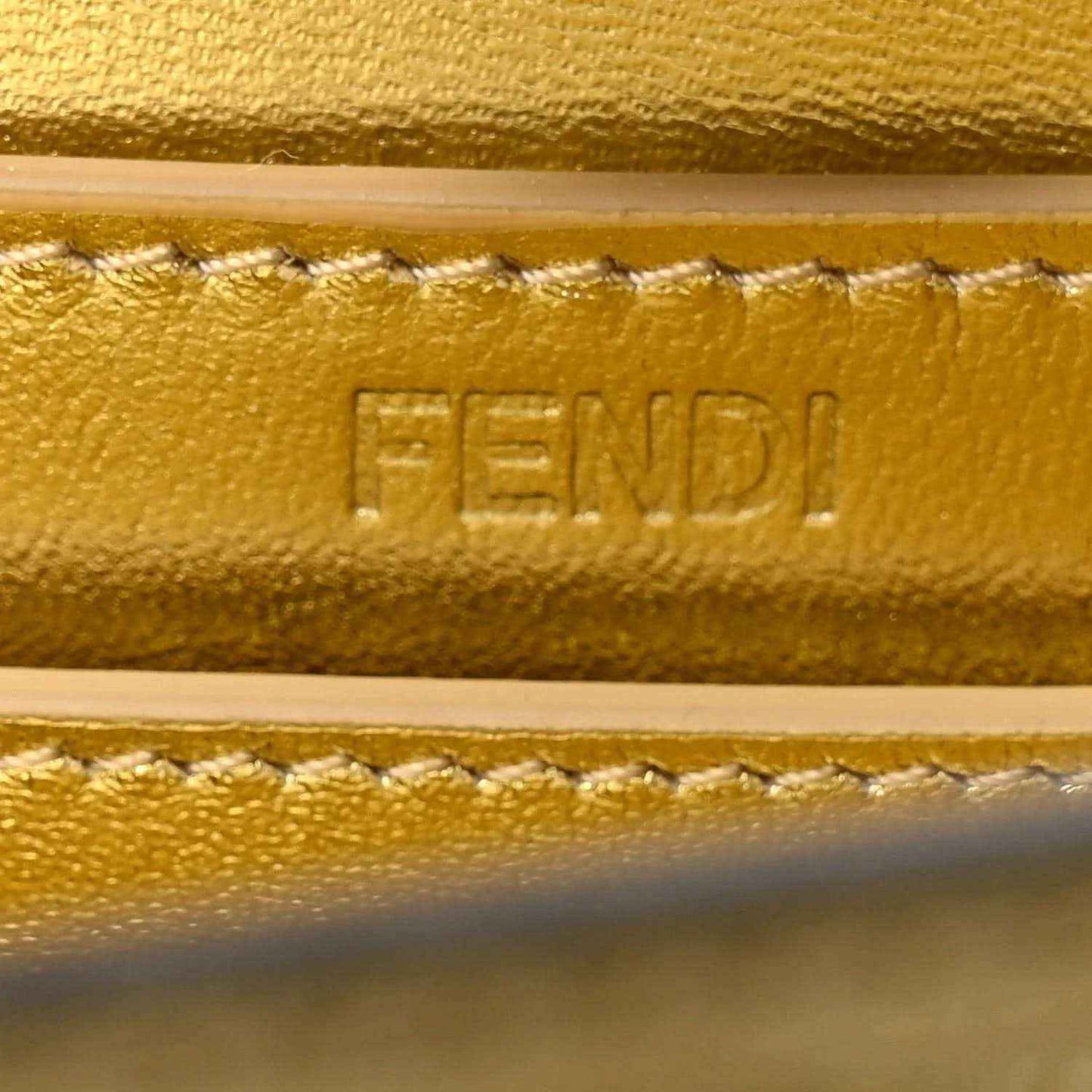 FENDI embossed on gold leather satchel edge with stitched trim detail