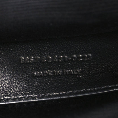 Leather brand stamp on black lambskin interior panel near zipper