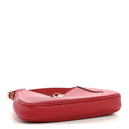 Red leather hobo bag with rounded shape and gold-toned hardware, shown flat
