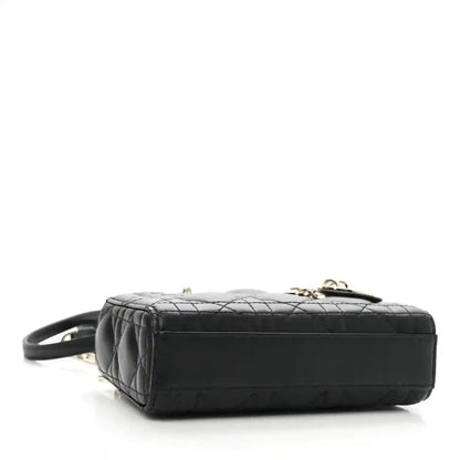 Black lambskin micro handbag with quilted top and short handle, rear view